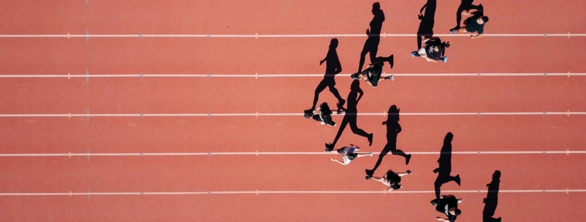 Group of people running on stadium