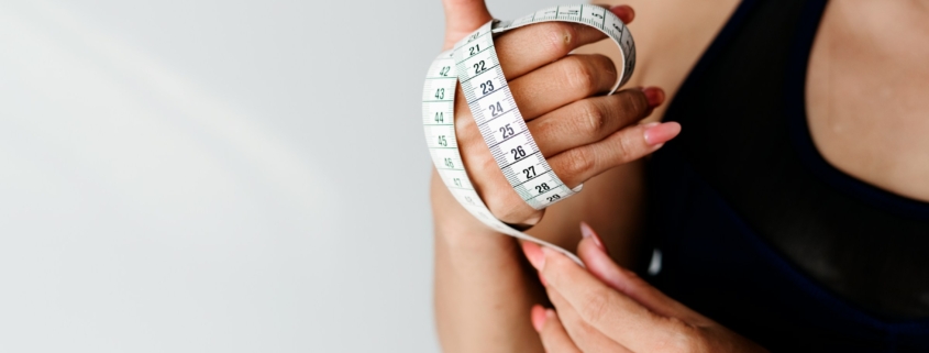 Asian woman with measuring tape