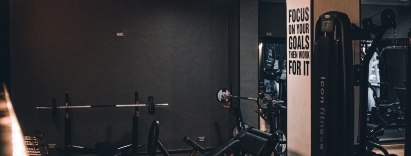A gym with a row of exercise machines