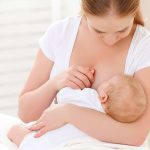 A mother nursing her baby.