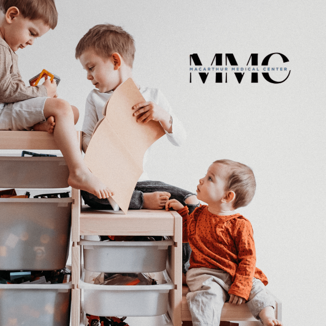 Three children sitting on different heights to indicate the stages of childhood.